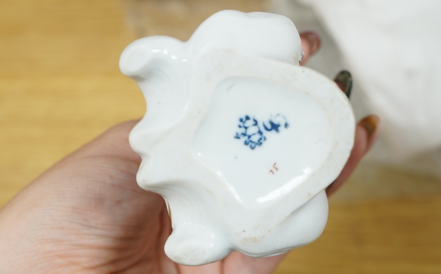 A French porcelain figure of a Mansion House dwarf, various German porcelain figures, an engraved glass and bowl. Glass 19cm